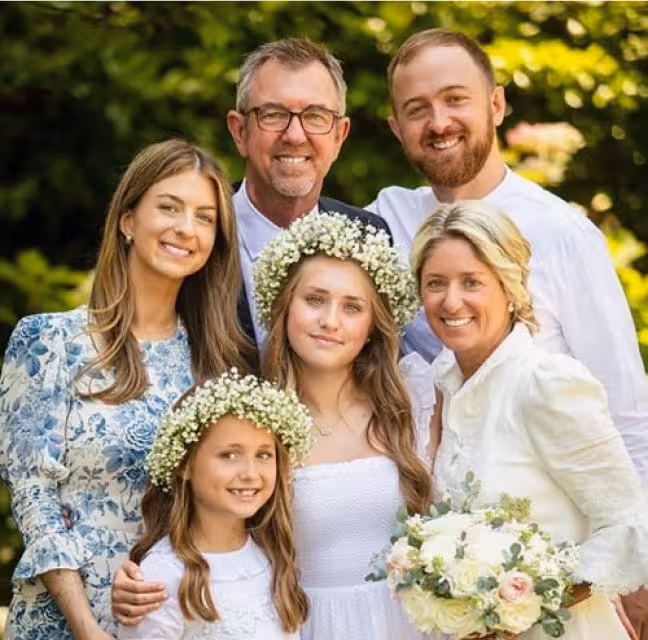 Dr. Michael Teichman, a Concord orthodontist, smiling with his family in an outdoor setting.